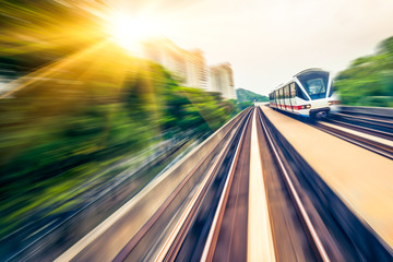 Obraz premium Sky train through the city center in Kuala Lumpur,motion blur