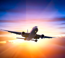 Airplane in the sky at sunrise