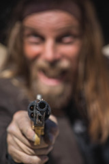 Fototapeta na wymiar Crazy Cowboy Points A Gun