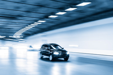 Fototapeta premium Interior of an urban tunnel with car,motion blur