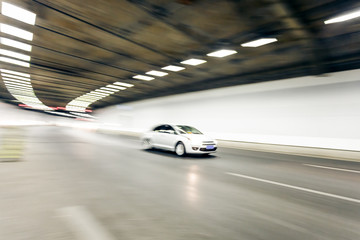 Interior of an urban tunnel with car,motion blur