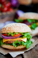 Closeup of home made burgers on wooden background