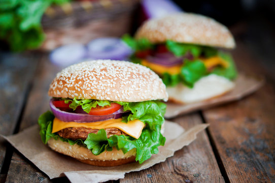 Closeup of home made burgers on wooden background