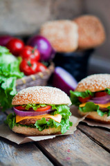 Closeup of home made burgers on wooden background