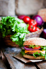 Closeup of home made burgers on wooden background