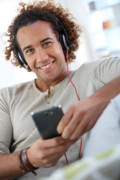 Cheerful attractive man listening to music
