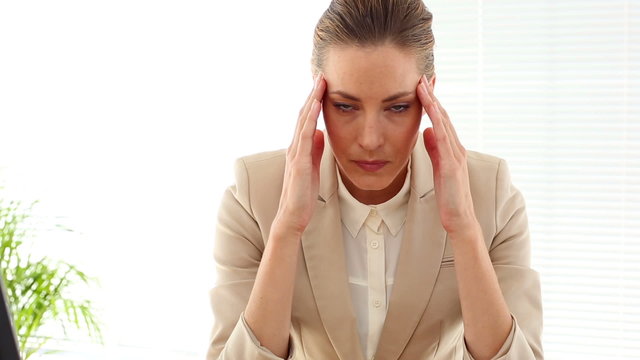 Businesswoman with a bad headache