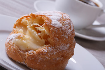 eclairs with custard on a plate closeup and coffee