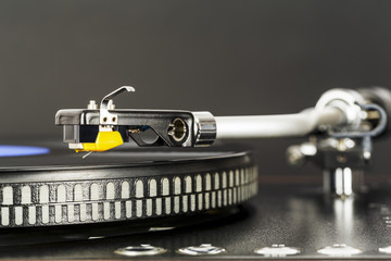 Phonograph cartridge waits over turntable
