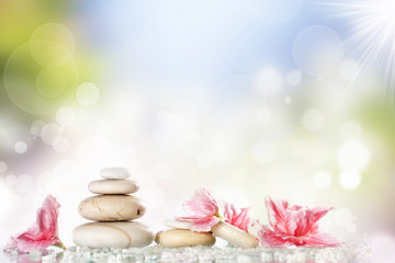 Obraz na płótnie Canvas White spa stones and flower on colorful background
