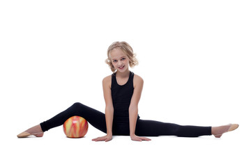 Fototapeta na wymiar Cheerful flexible young gymnast posing on split
