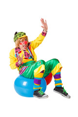 Funny clown sits on blue ball