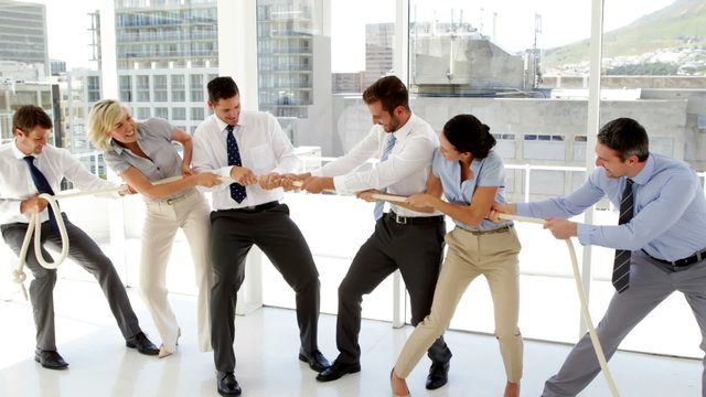 Business people having a tug of war