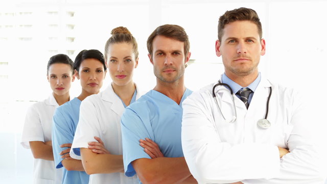 Frowning medical team with arms crossed