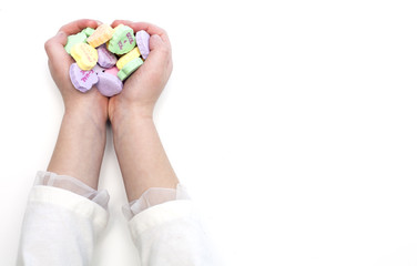 Colorful sweet heart candy in child hands
