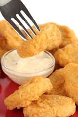Fried chicken nuggets with sauce isolated on white