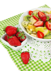 Useful fruit salad of fresh fruits and berries in bowl isolated