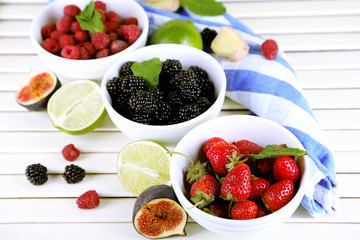 Assortment of juicy fruits and berries on wooden background