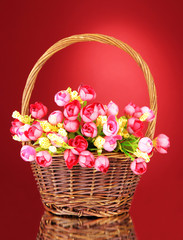Fototapeta na wymiar Bouquet of beautiful artificial flowers in wicker basket,