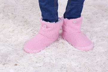 Female legs in blue jeans trousers and home winter shoes,