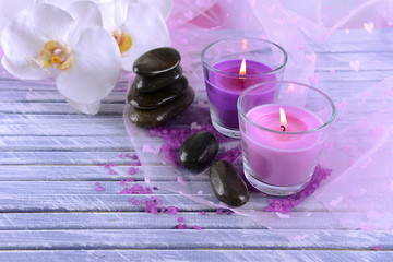 Beautiful colorful candles and  orchid flowers,