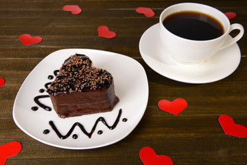 Sweet cake with chocolate on plate on table close-up