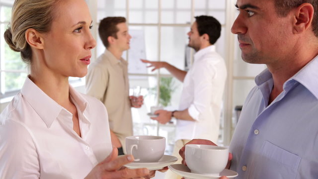 Colleagues chatting while having a break