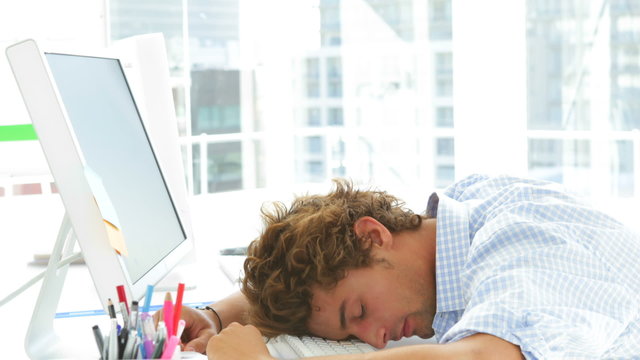Attractive businesswoman waking up and falling asleep again