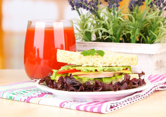 Fresh and tasty sandwich on plate on table on light background