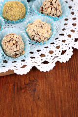 Set of chocolate candies, on tray, on wooden background