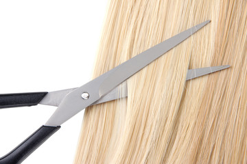 Long blond hair and scissors close up