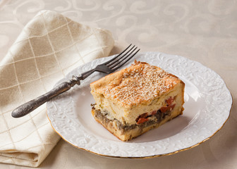 Portion cheese soufflé topped with sesame seeds on a white plat