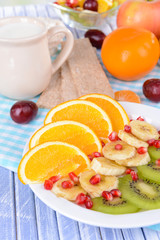 Sweet fresh fruits on plate on table close-up