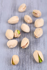 Pistachio nuts on wooden background