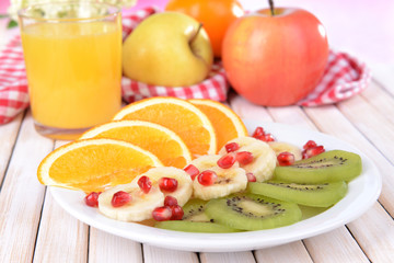 Sweet fresh fruits on plate on table close-up