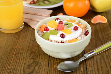 Delicious oatmeal with fruit in bowl on table close-up