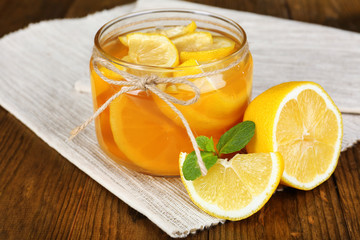 Fototapeta na wymiar Tasty lemon jam on table close-up