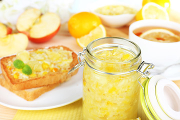 Delicious toasts with lemon jam on plate on table close-up