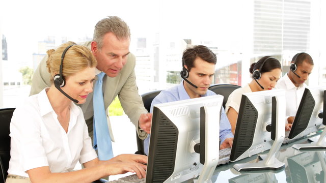 Manager checking in on call centre employees