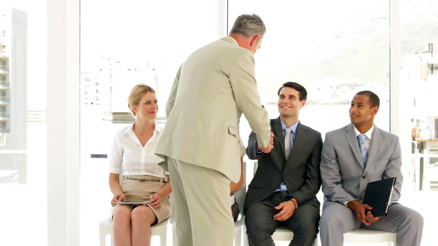Businessman taking applicant away to be interviewed