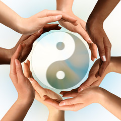 Multiracial Hands Surrounding Yin Yang symbol