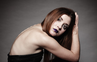 Naklejka premium Sad unhappy girl young woman with long hair and creative makeup