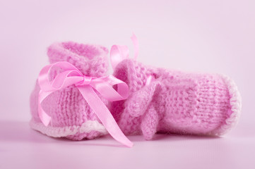 Knitted baby booties on a background
