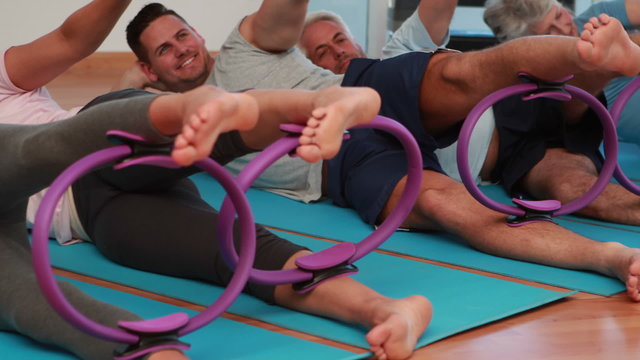 Pilates class lying down using pilates rings