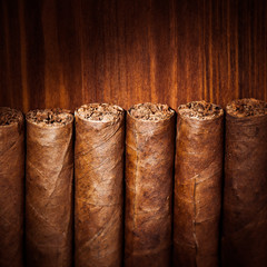 cigars on wooden background