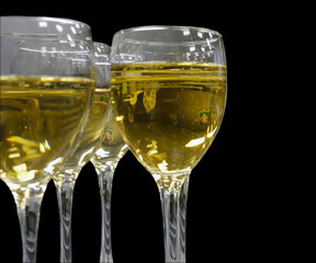 Champagne in glasses closeup on black background.