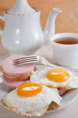 fried eggs, sausage sandwiches