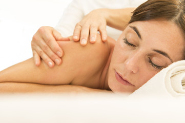 Obraz na płótnie Canvas Beautiful young woman having a massage in a spa