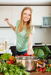 woman cooking from raw vegetables in home