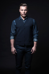 Obraz premium Retro winter fashion man. Wearing blue jeans shirt with gilet an